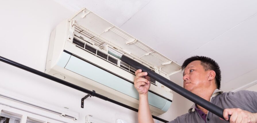 technician servicing the indoor air-conditioning unit - Spring Service & Heating Ltd.