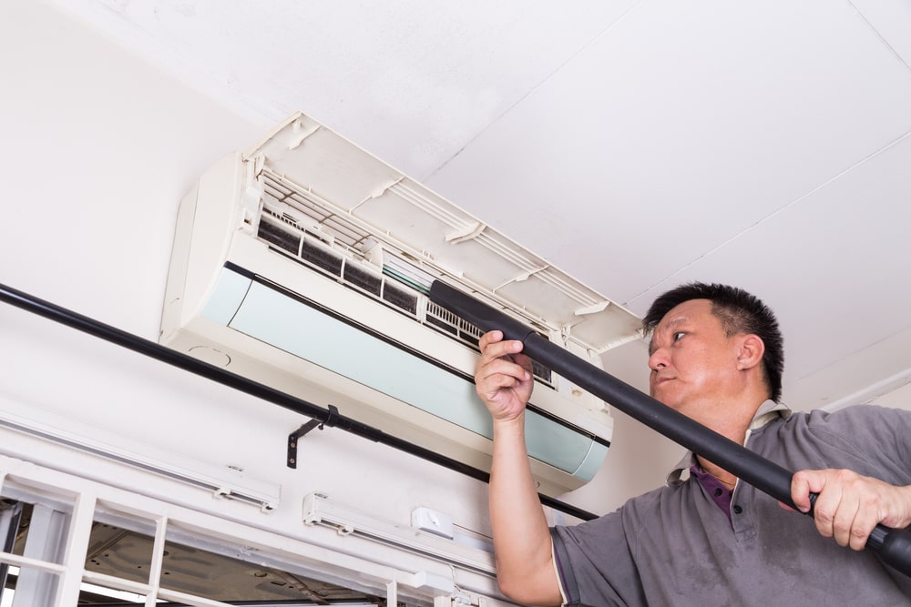 technician-servicing-the-indoor-air-conditioning-unit-Spring-Service-Heating-Ltd.